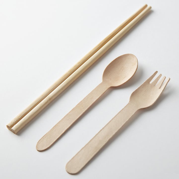 An image of wooden cutlery, including a chopsticks, spoon and fork